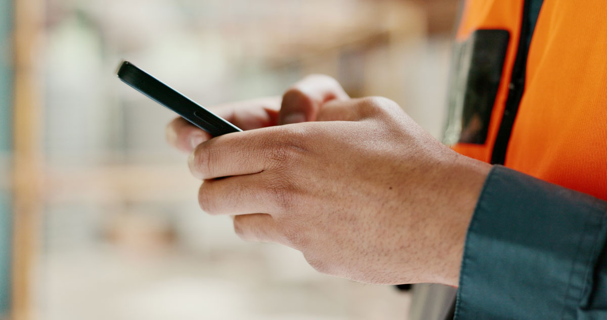 Close-up shot of hands holding a mobile device.