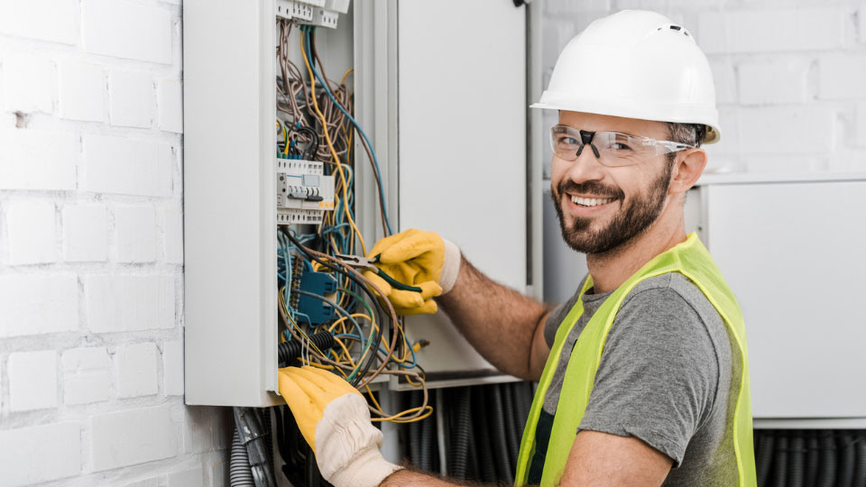 Worker checking electric panel