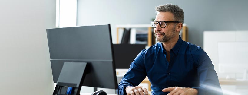 Person in an office environment looking at a computer