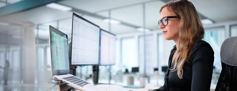 Person in an office setting looking at a computer