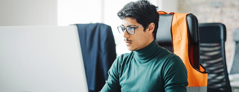 Person in an office setting looking at a computer