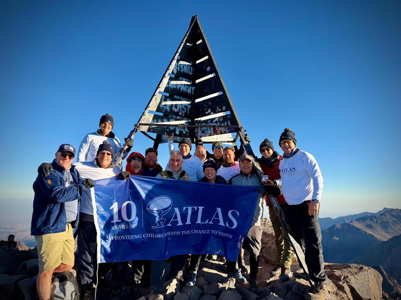 A group of people representing the Atlas Foundation at the peak Mount Toubkal