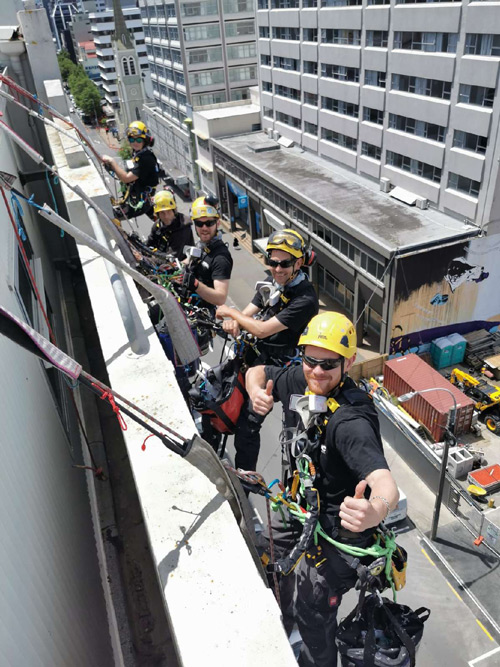people scaling the outside of a tall building