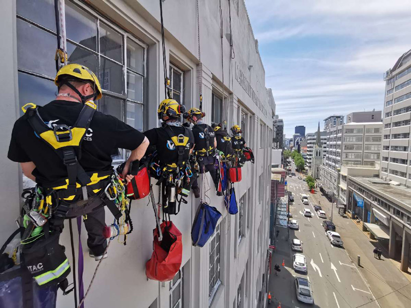 people scaling the outside of a tall building