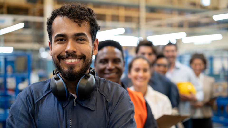 smiling workers in factory setting