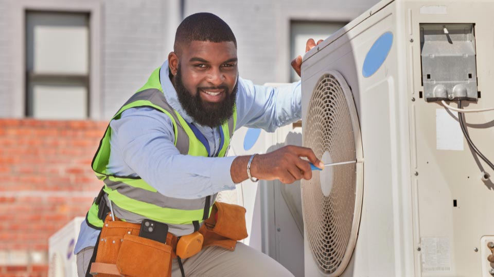 HVAC technician working on air conditioning unit