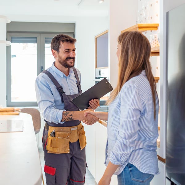 Worker and customer shaking hands after discussing a job