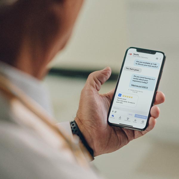 Man holding smartphone reading text messages