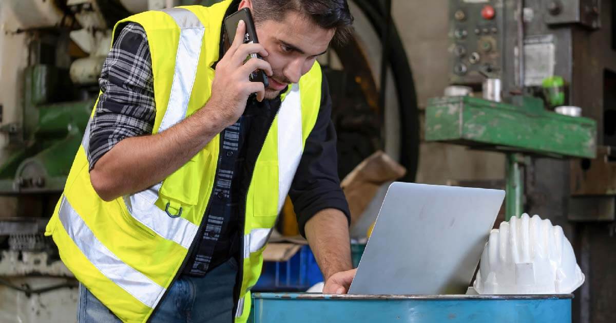 Worker talking on the phone and using laptop