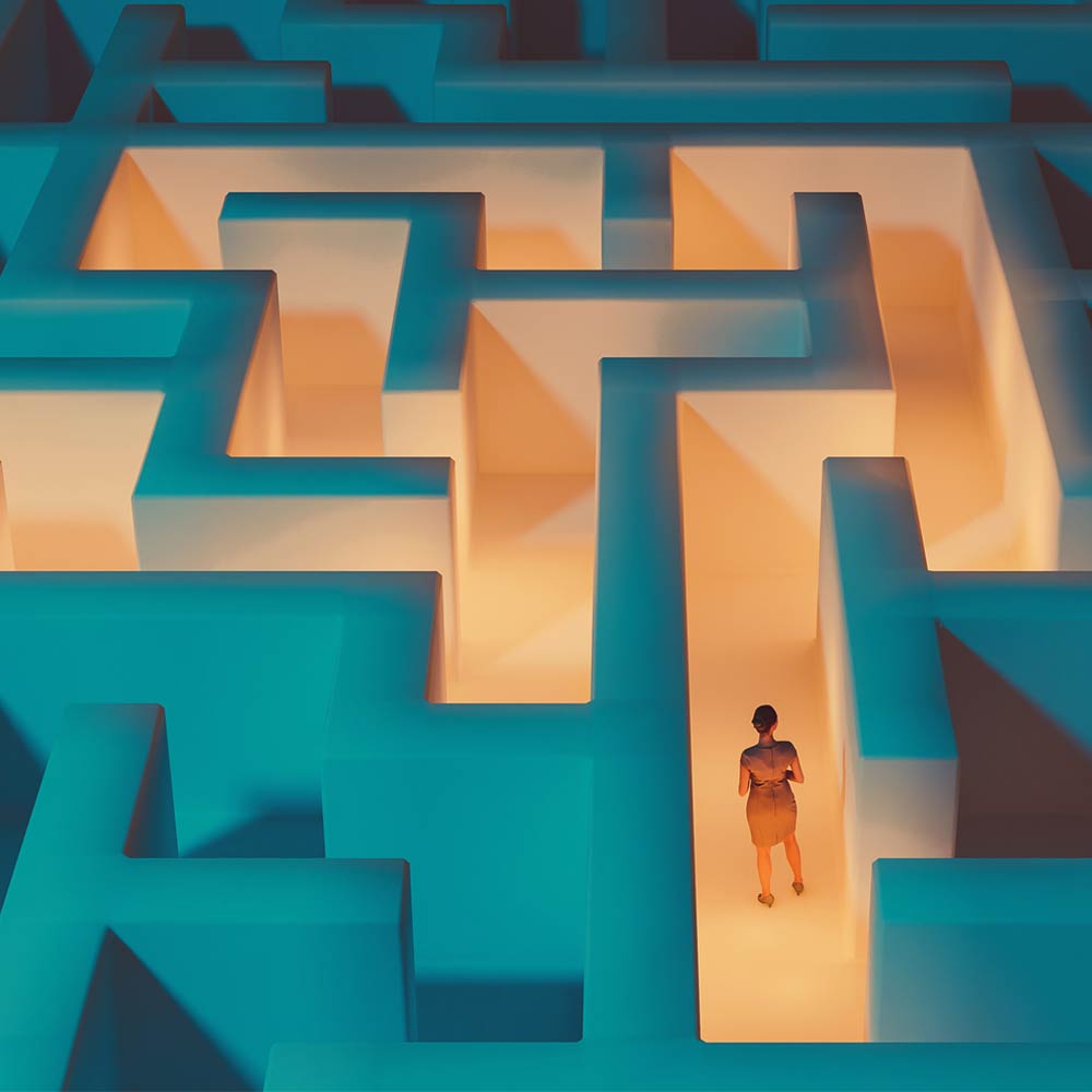 A person stands in a maze with an orange glow