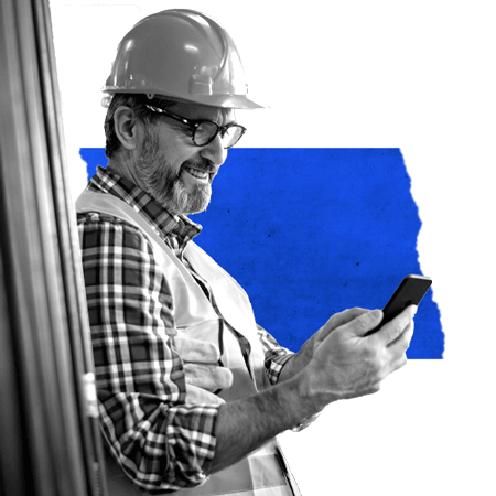 Man wearing a hard hat and safety vest looking at his phone checking the updated visibility and management features