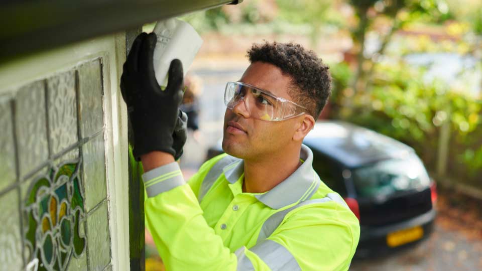 security installer installing home security equipment