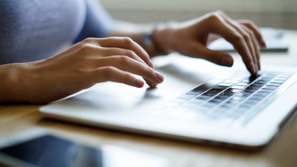 Hands typing on a keyboard