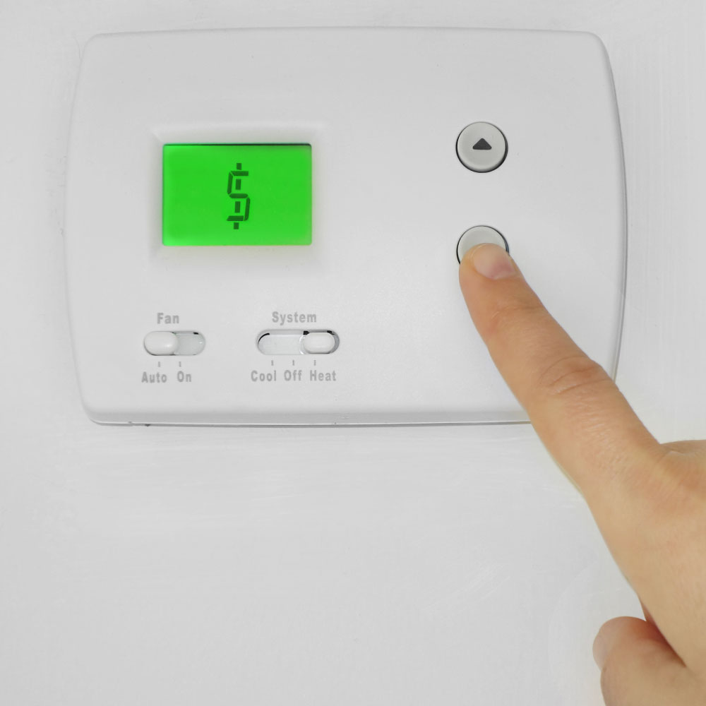 A thermostat with a dollar sign shown on the electronic screen