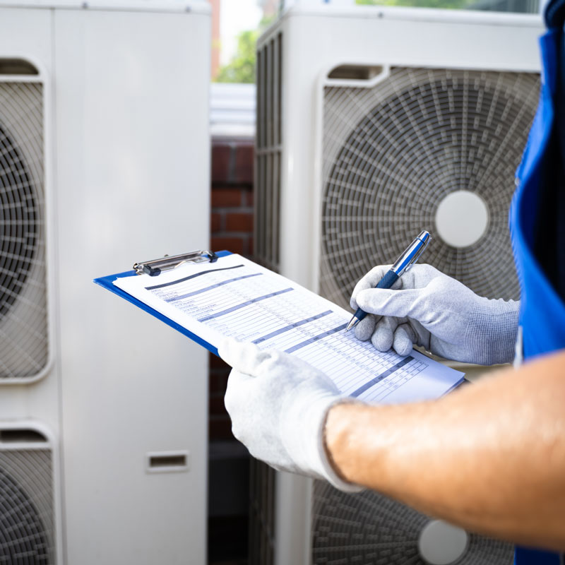 HVAC preventative maintenance checklist being held on a clipboard