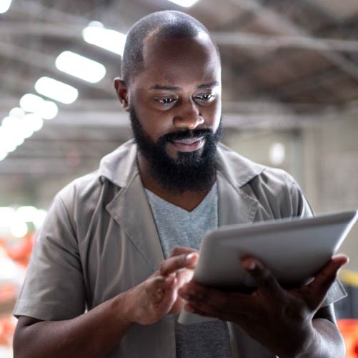 Man working in warehouse using tablet