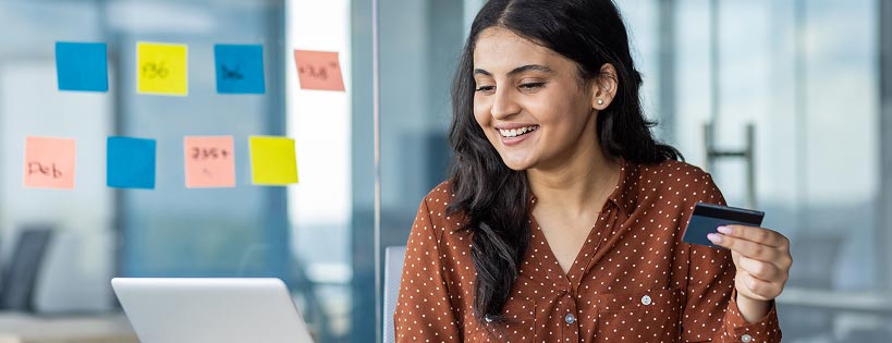 person in office setting holding credit card