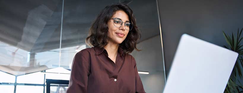 person in office settign looking at computer screen