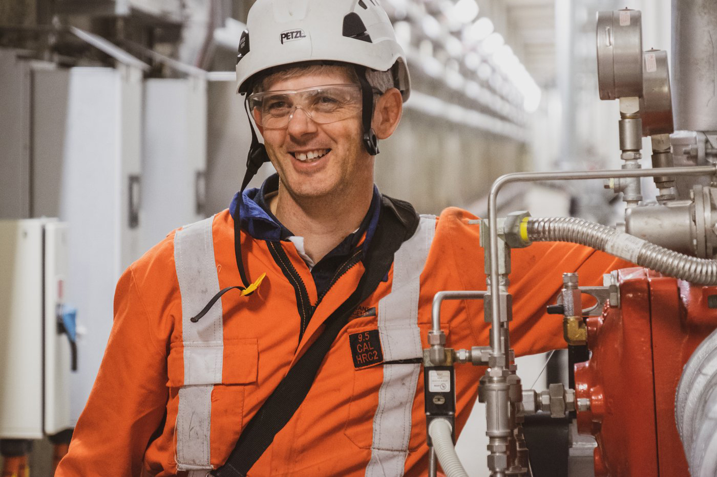 Armitage worker standing by industrial pipes