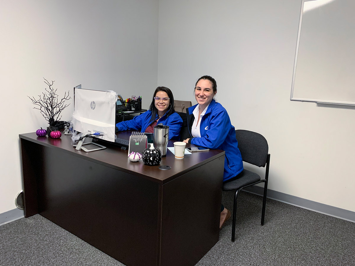Blue Wave Communications staff members sitting at a desk