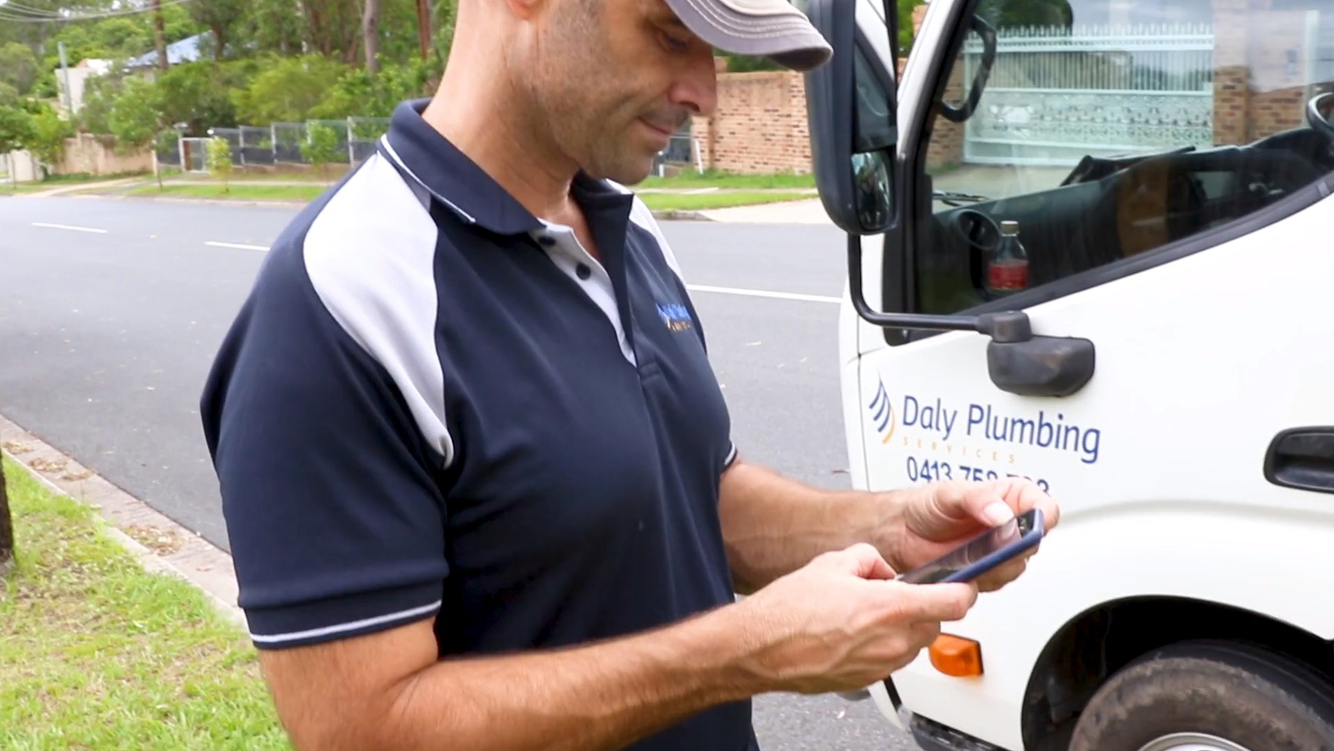 Daly Plumbing worker Matt Daly, operating a mobile phone 