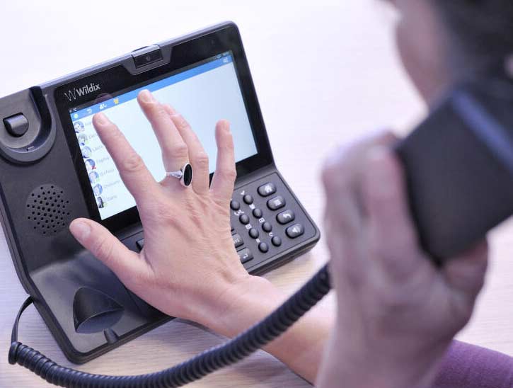 office staff member using desk phone