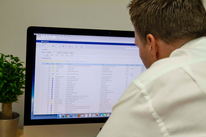 DT Fire Systems worker operating a desktop computer