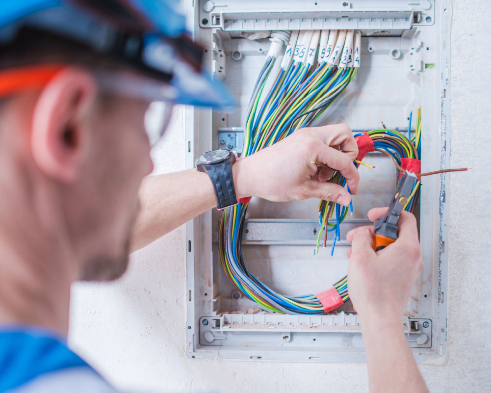 Electrician connecting wires on a board