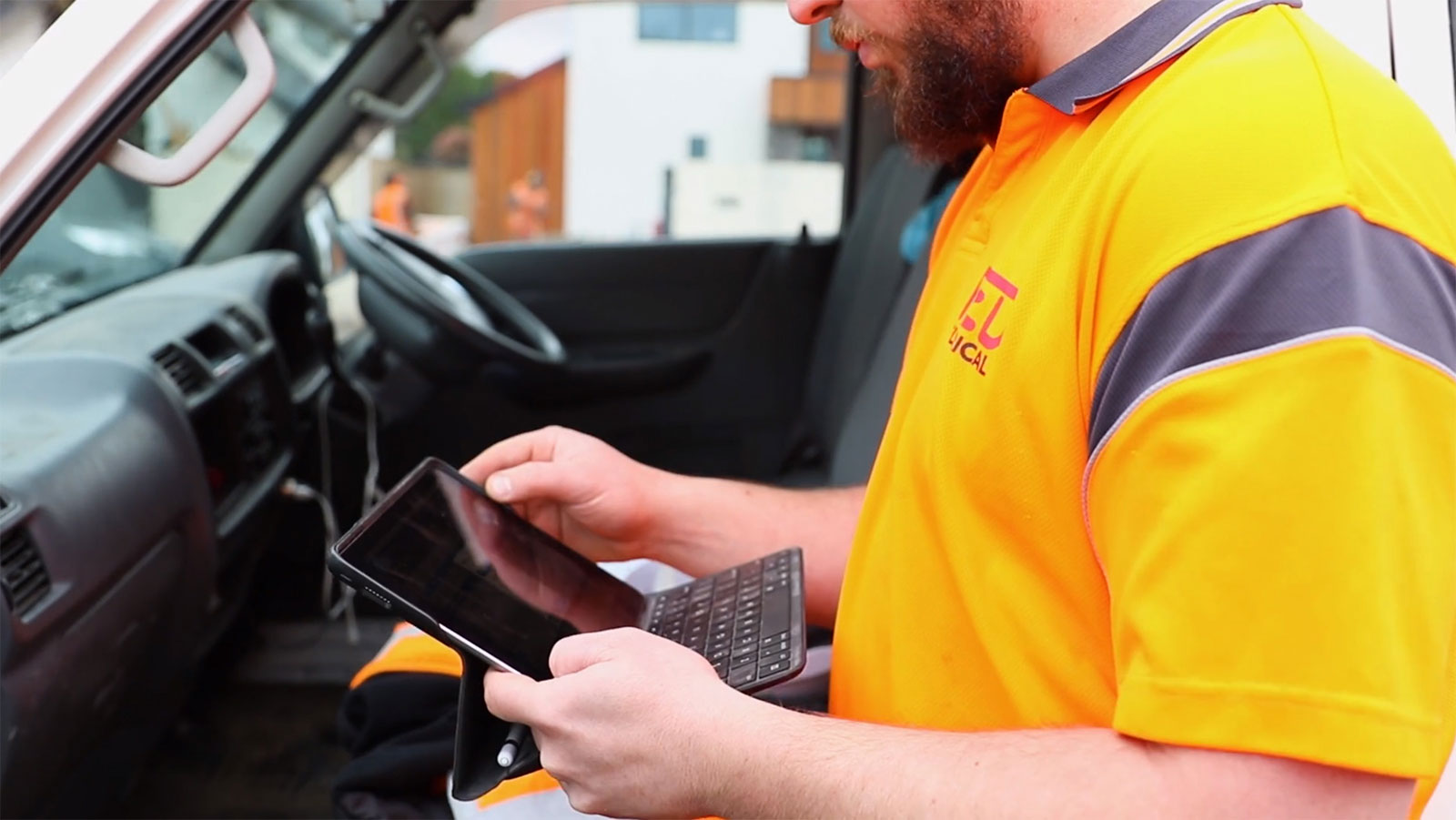 RED Electrical worker operating a tablet