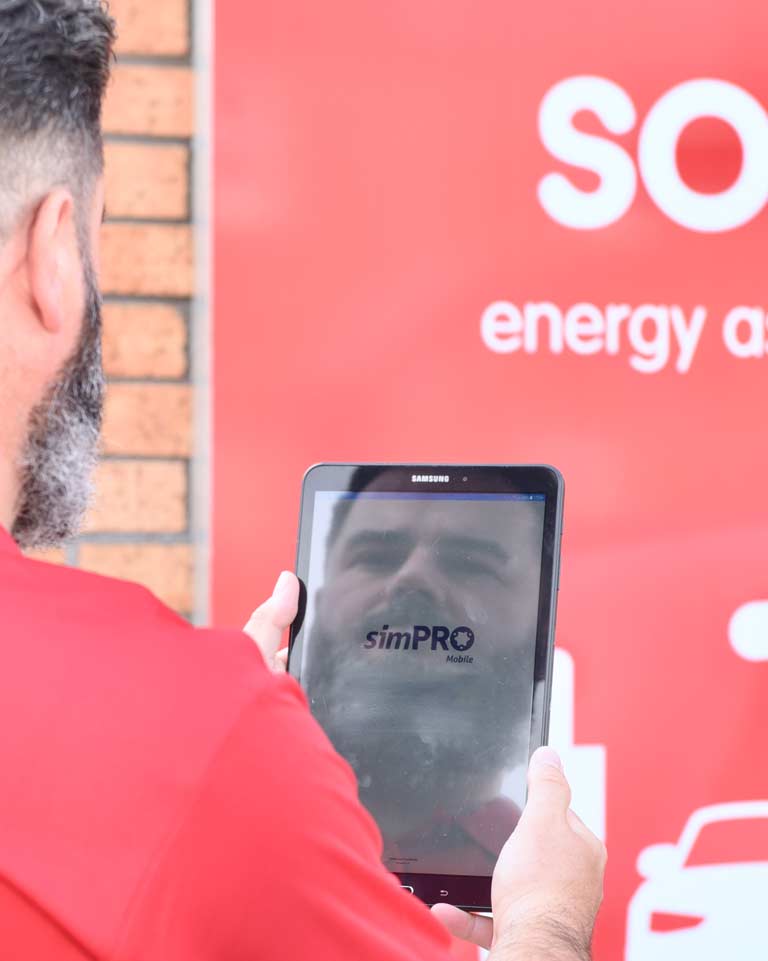 Solv staff member using Simpro on a tablet