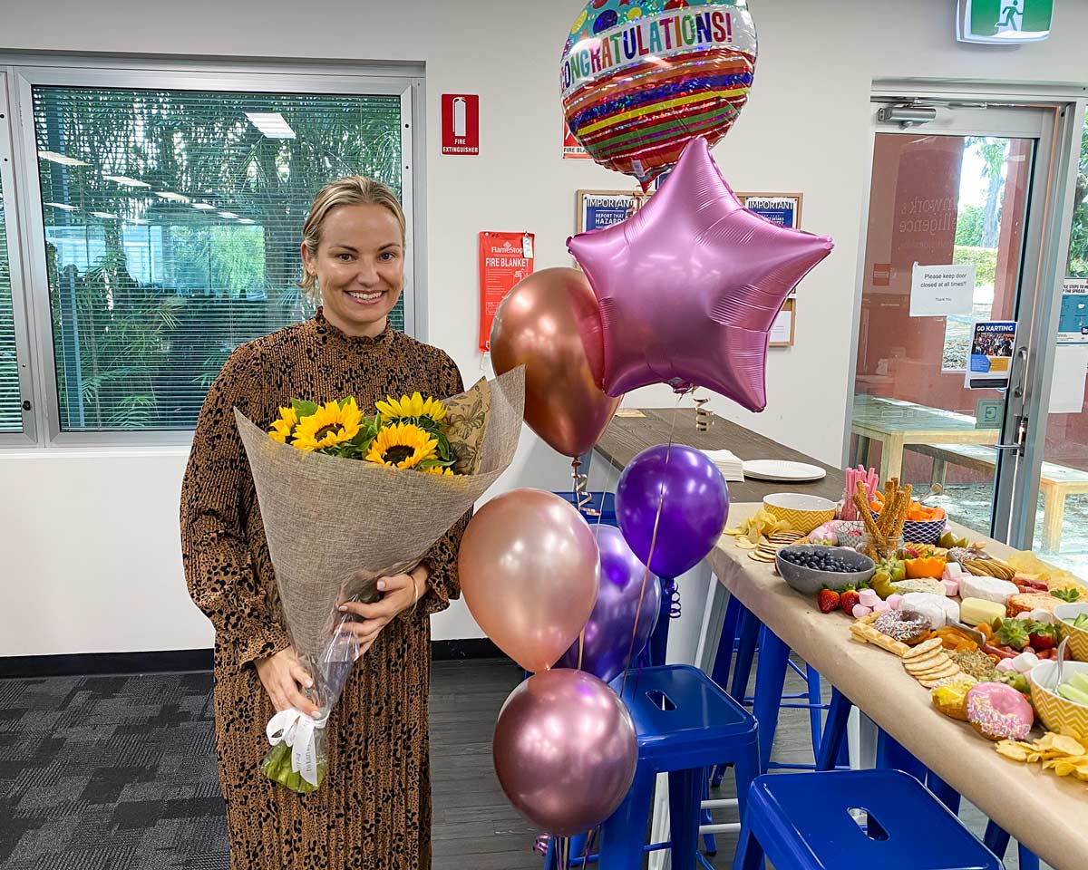 Hayley with flowers and balloons