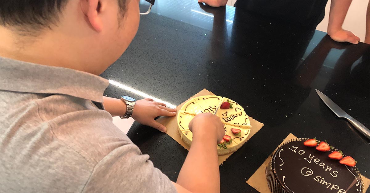 Rick Lan cutting 10 year anniversary cake