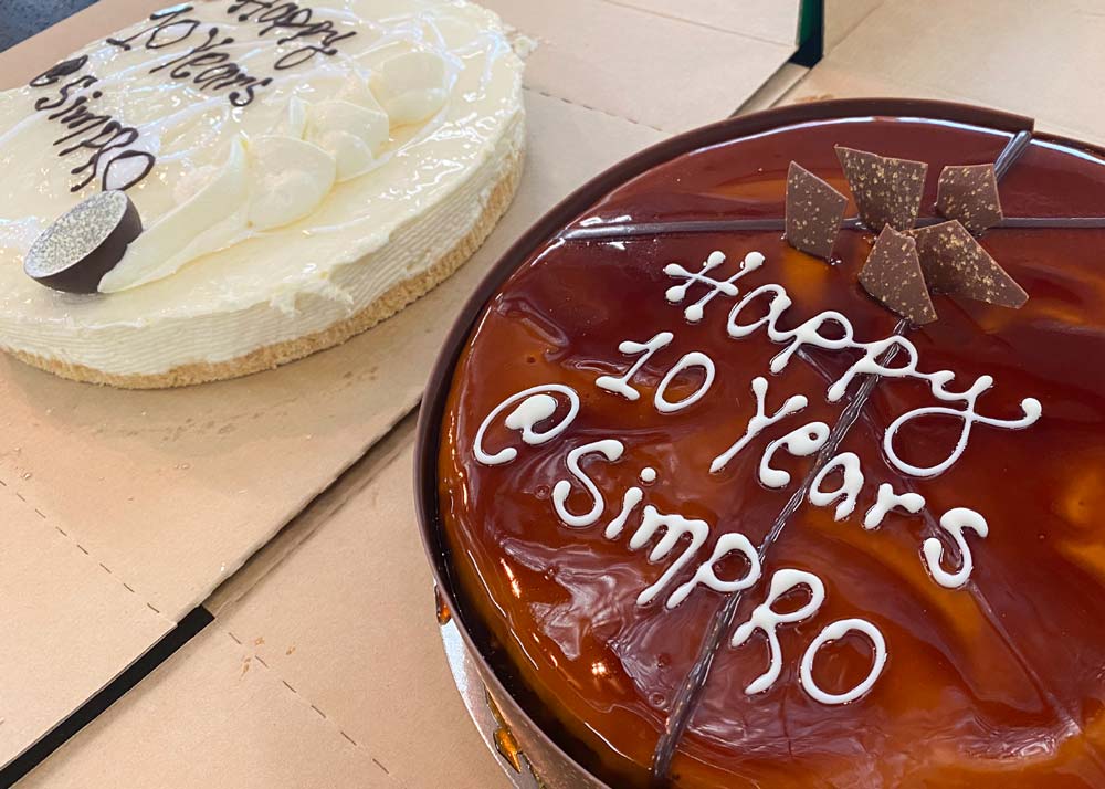Two cakes celebrating Wayne's 10 years at Simpro.