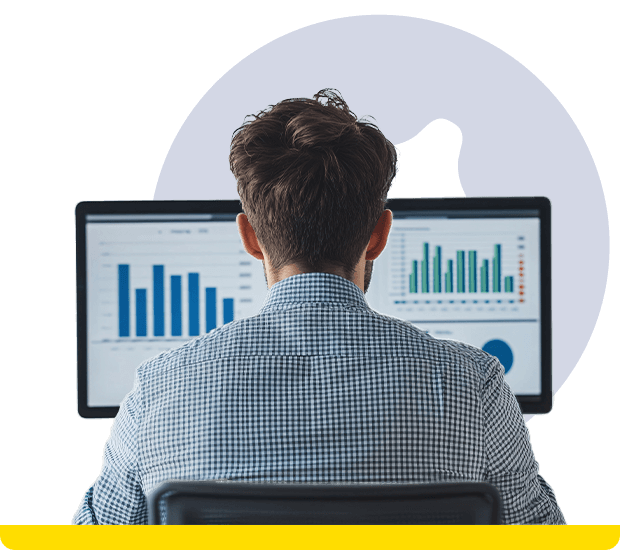 Person analyzing data on dual monitors with charts