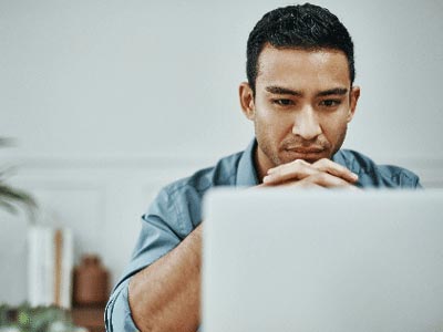 person sitting behind notebook computer