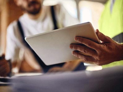 person showing another person something on tablet device