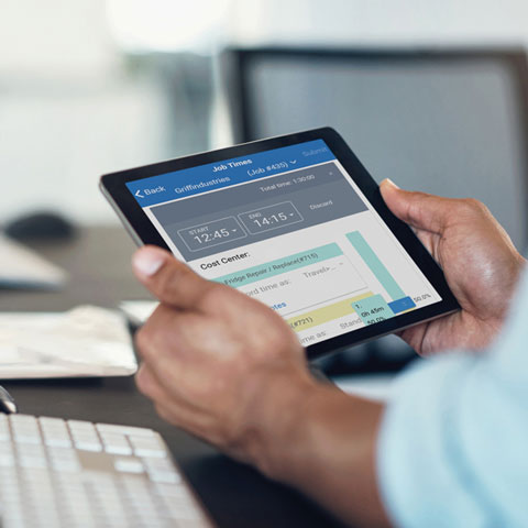 User holding tablet with simPRO timesheets visible